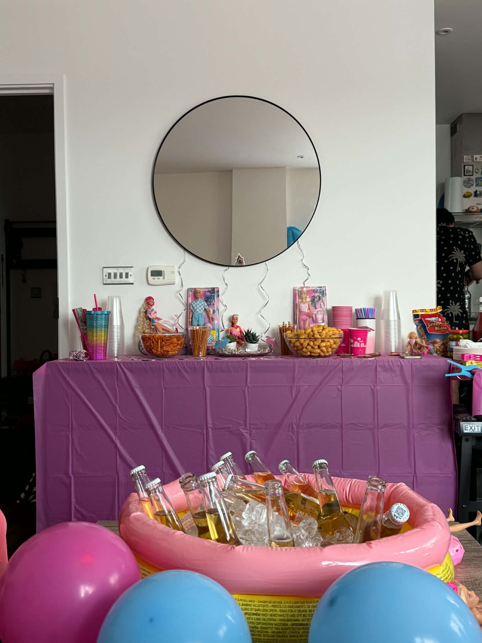 Pink doll-themed party decorations and table styling.